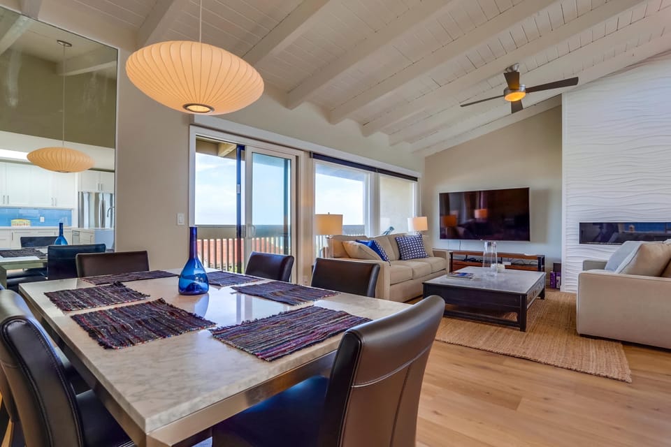 The dining area flows seamlessly into the living room and balcony.