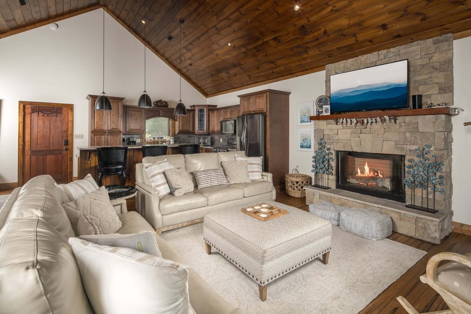 Inviting living area with fireplace, vaulted ceilings, and mountain views