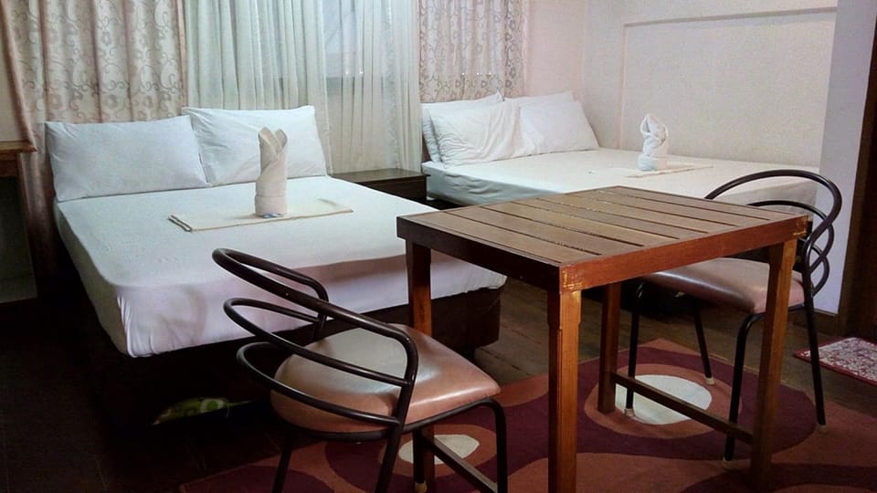 Family Room | Desk, laptop workspace, bed sheets