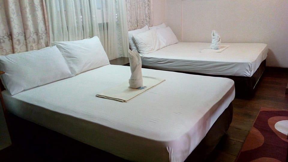 Family Room | Desk, laptop workspace, bed sheets