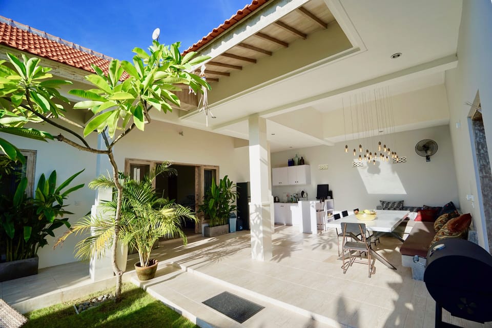 Dining area overlooks the tropical garden + pool