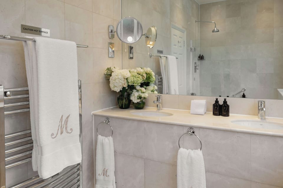 Combined shower/tub, designer toiletries, hair dryer, bathrobes