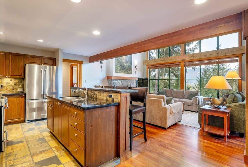 - Modern kitchen with granite counters and stainless appliances  
- Open layout connects to bright living and dining spaces  
- Perfect setup for family meals after a day on the slopes  