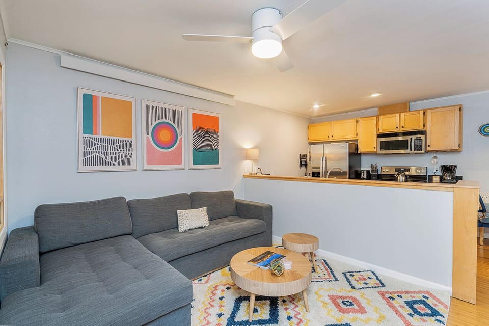 Bright and colorful open living area featuring a large cozy couch and entertainment space—ideal for unwinding after a fun day in Telluride.