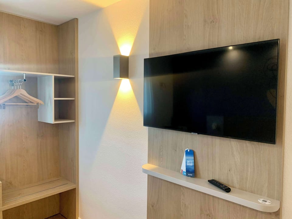 Premium bedding, desk, laptop workspace, blackout drapes