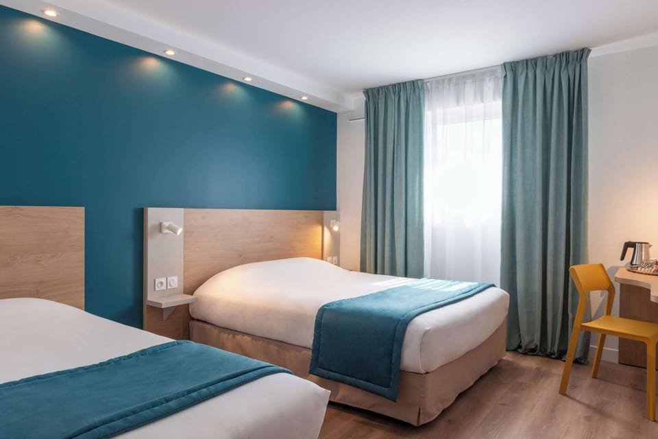 Premium bedding, desk, laptop workspace, blackout drapes
