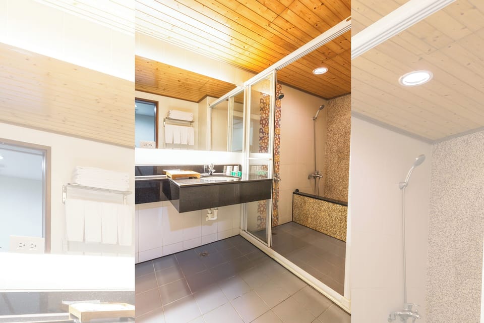 Deluxe Quadruple Room, 2 Queen Beds | Bathroom | Rainfall showerhead, hair dryer, slippers, towels