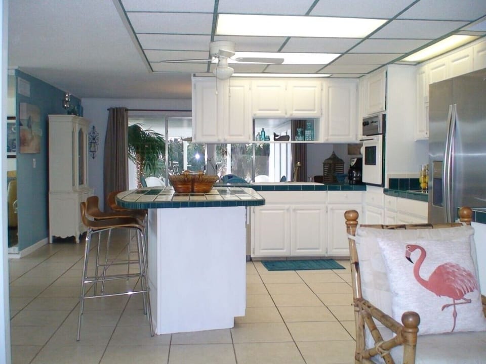 Open kitchen floor plan with tropical tiled island for a real beach cottage feel