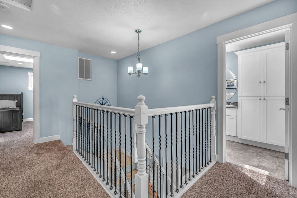 Bright upstairs landing with soothing blue walls creates a welcoming transition between your private spaces and shared areas.