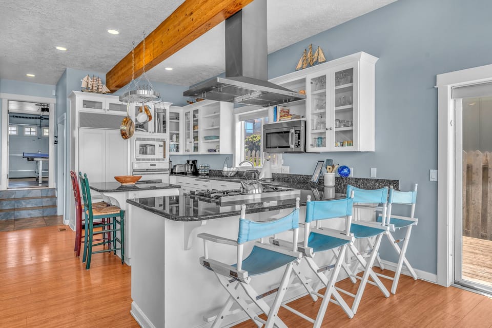 Your spacious kitchen features granite counters, professional appliances, and a breakfast bar where you'll love gathering for morning coffee.