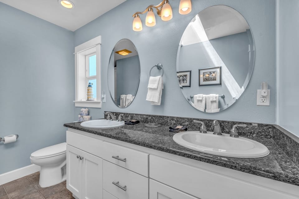 Your spacious bathroom features dual vanities with granite counters, perfect for sharing morning routines in elegant comfort.