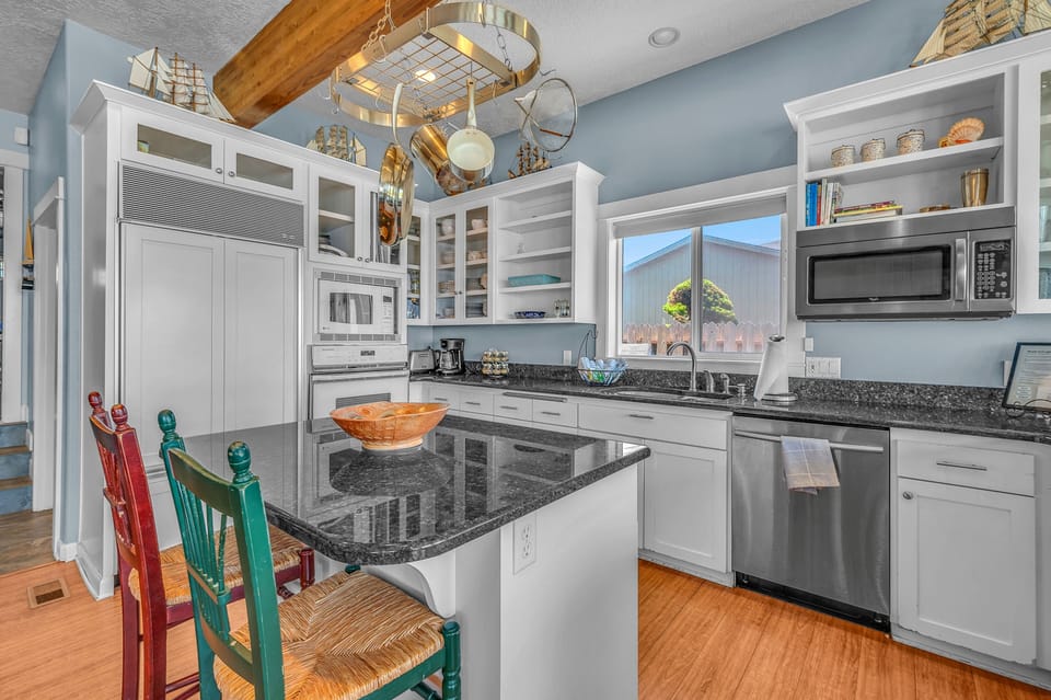 Prepare memorable meals in your fully equipped kitchen with granite countertops, stainless appliances, and charming nautical touches throughout.
