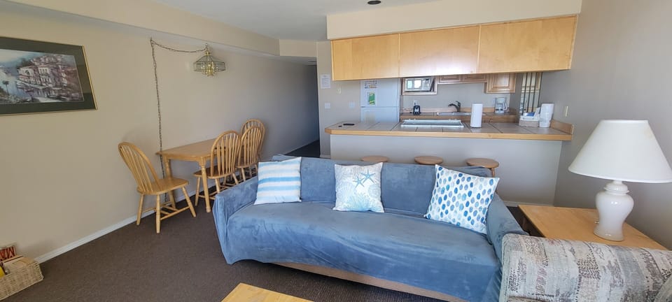 Settle into your cozy open-plan living space where you can relax on the comfy sofa, enjoy home-cooked meals at the dining table, and whip up your favorite dishes in the well-equipped kitchen.