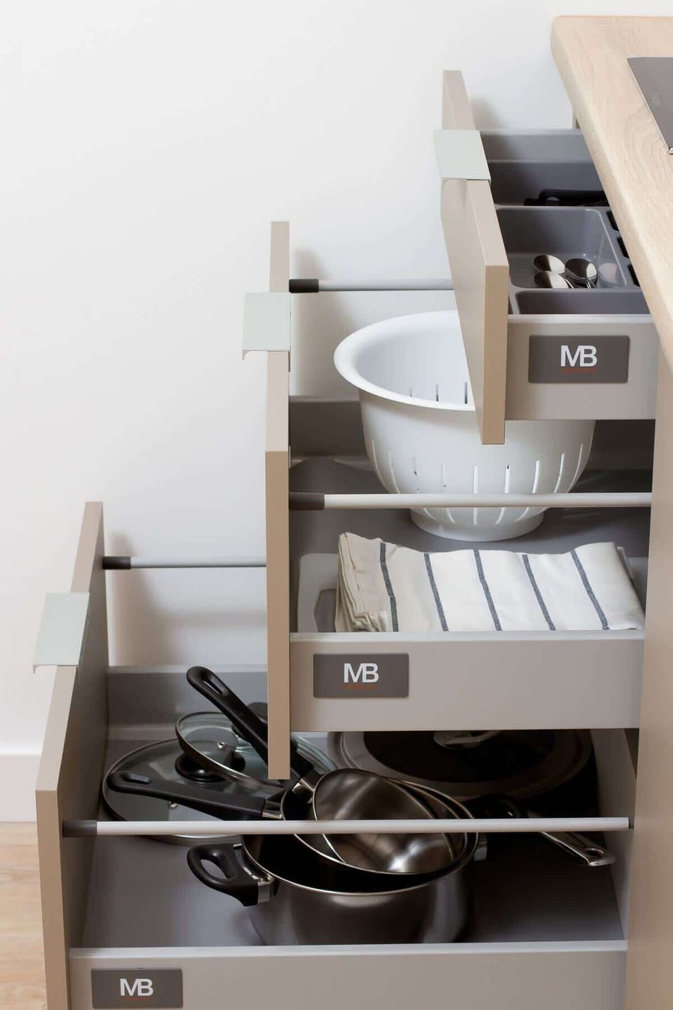 An open kitchen cabinet showcasing neatly arranged dishes and utensils. The shelves provide easy access and help keep the space organized.