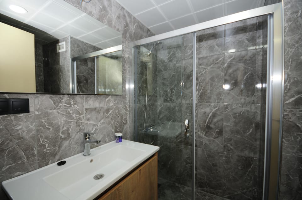Shower, rainfall showerhead, hair dryer, towels
