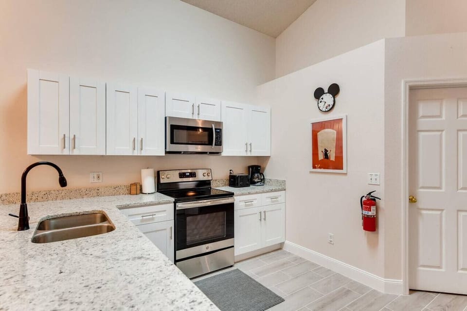 Well-equipped kitchen with ample cabinetry and stunning granite countertops.