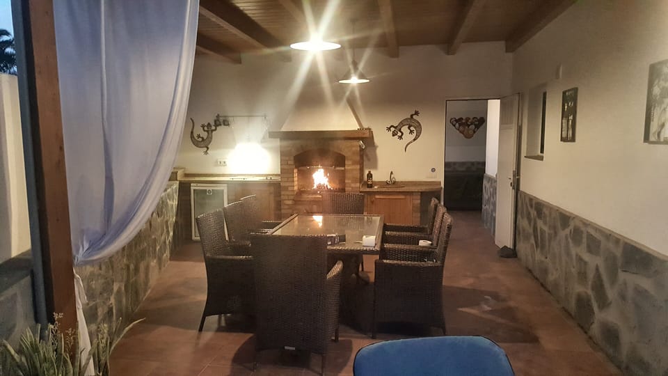Night time in the BBQ undercover pergola dining area 