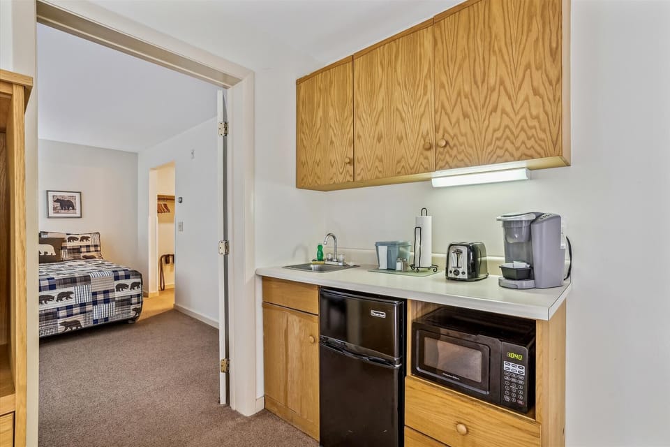Coffeepot, microwave, toaster, and mini fridge.
