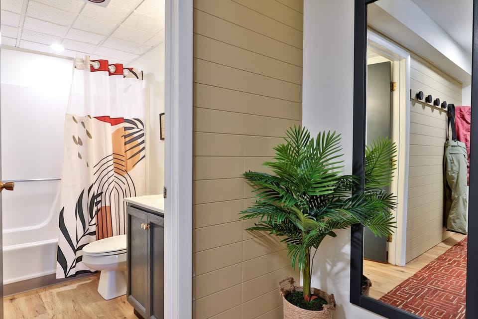 Bathroom and shower view with hallway mirror