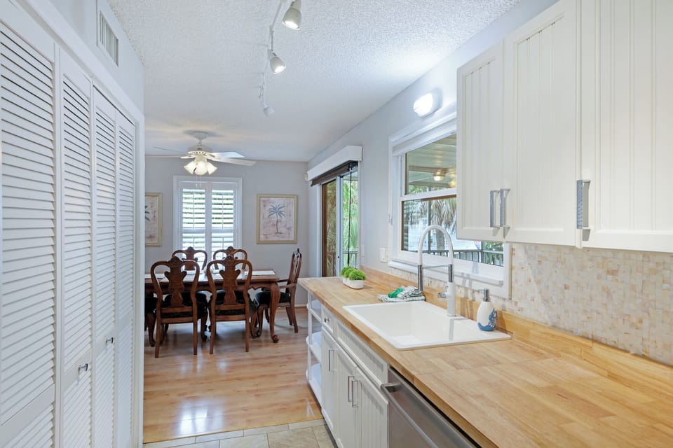Modern kitchen and laundry room behind doors.
