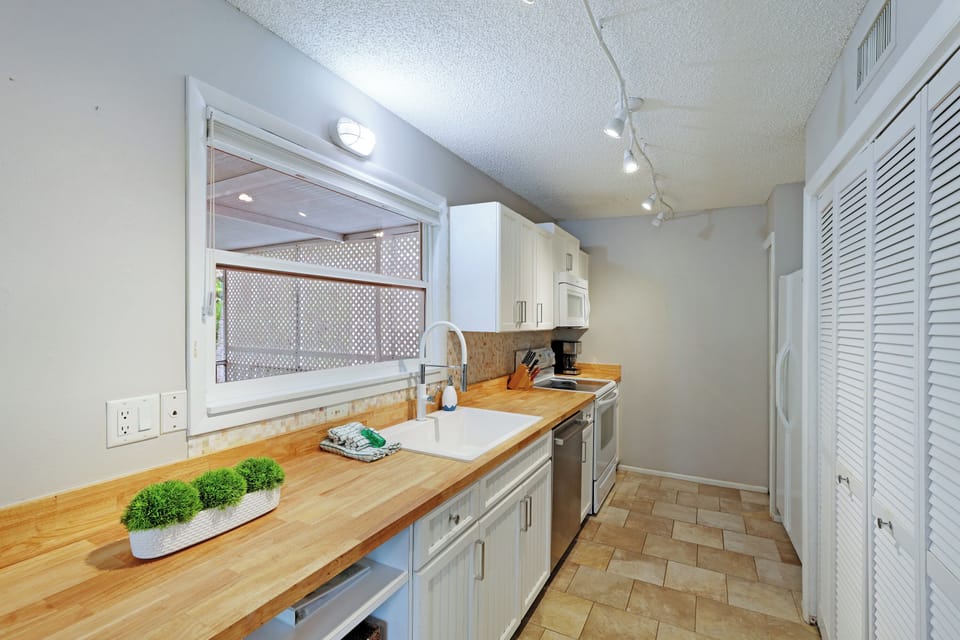 Modern kitchen. Laundry room located behind doors.