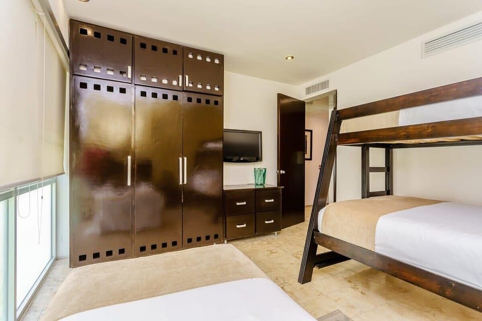 Bedroom 3 has ample storage space & a tv too
