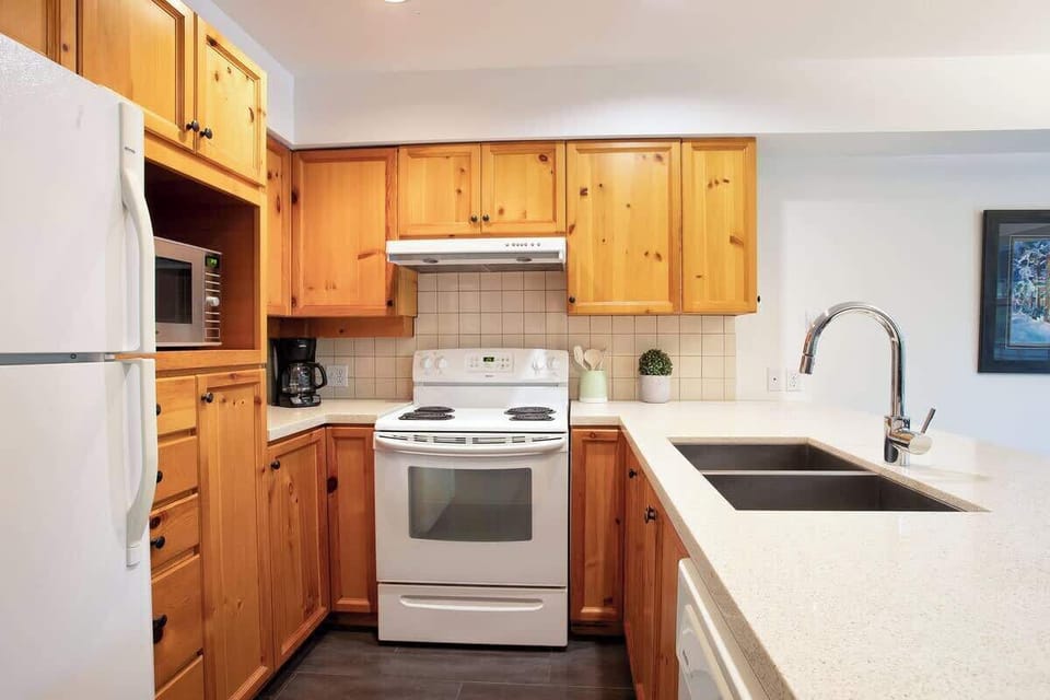 - Well-equipped kitchen with modern appliances and wood accents  
- Generous counter space for preparing home-cooked meals  
- Inviting setup combining rustic warmth and practical comfort  