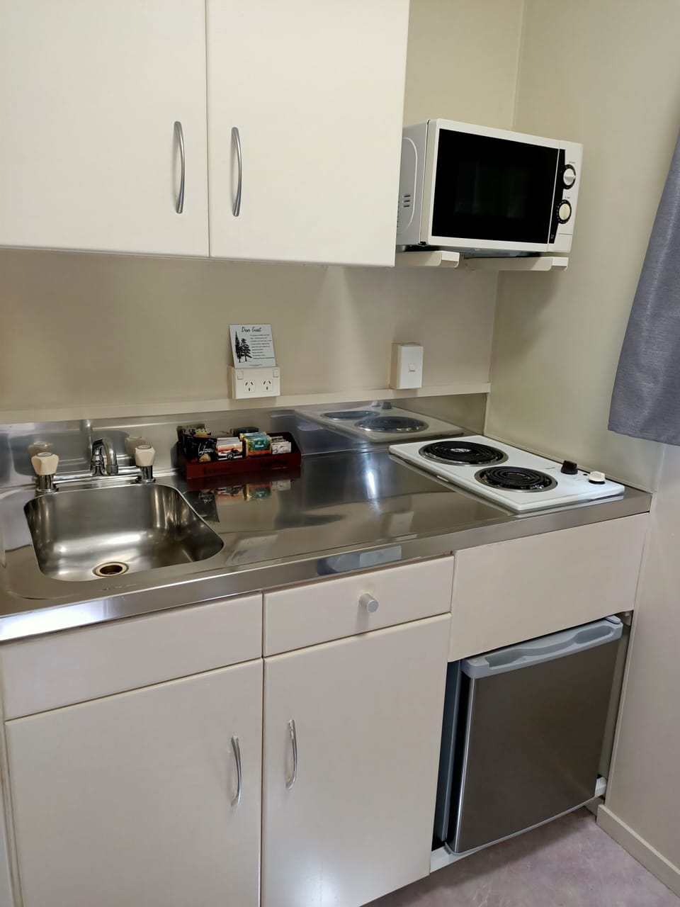 Fridge, microwave, coffee/tea maker, cookware/dishes/utensils