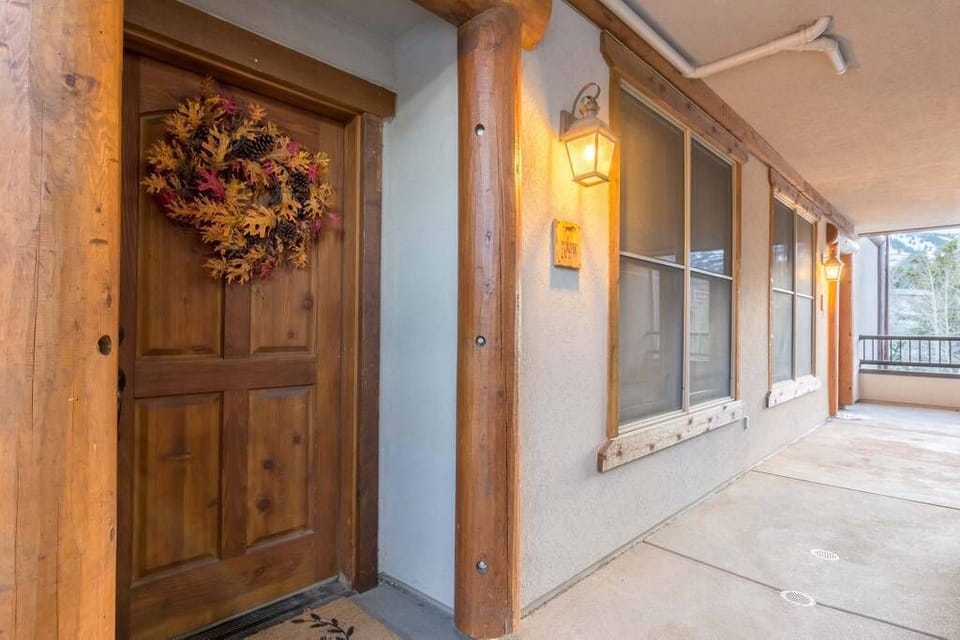 Welcoming entrance with rustic wood details and autumn wreath creates a cozy mountain retreat atmosphere for your arrival.