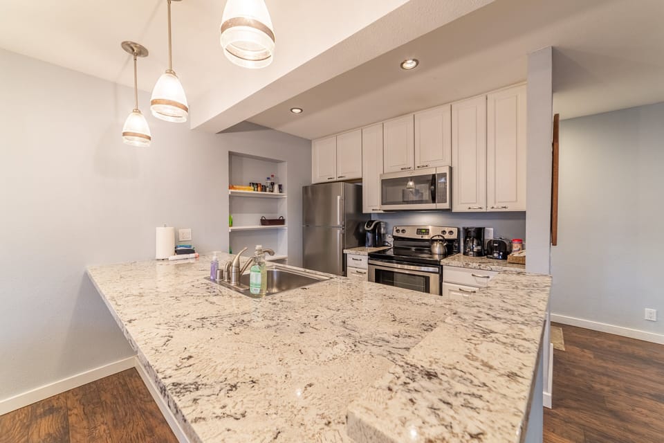 Updated kitchen with granite countertops and stainless steel appliances