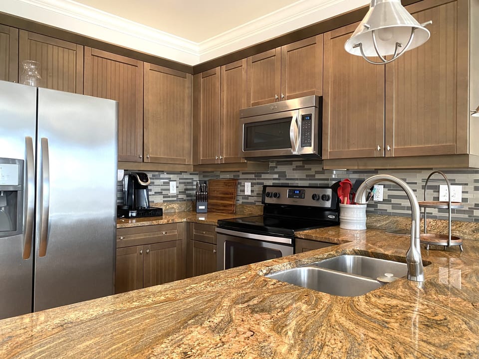 Kitchen featuring stainless appliances & granite countertops 
