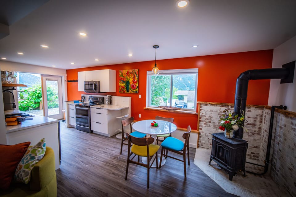 Spectacular open-concept kitchen and dining with vibrant red accent wall