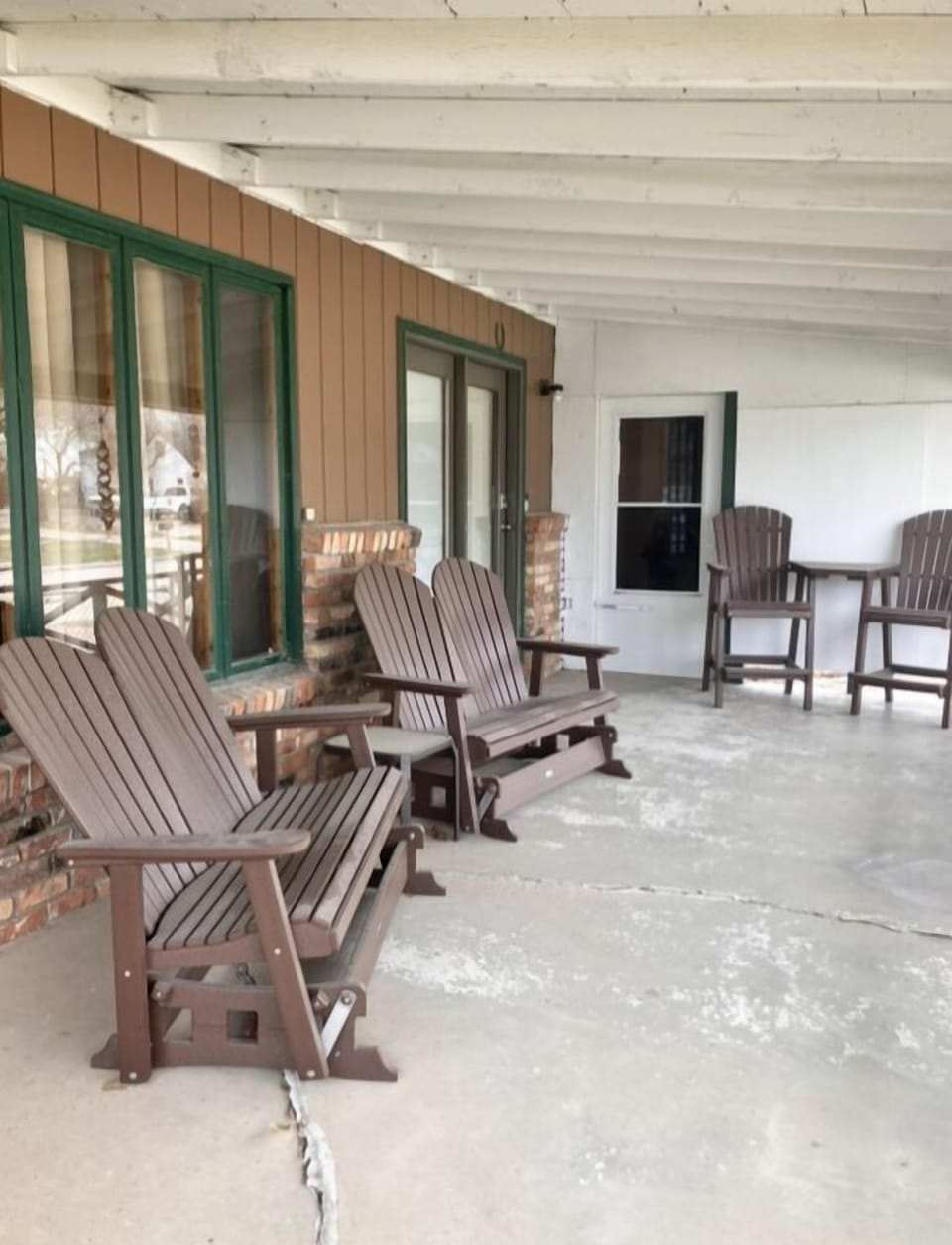 Seating for 8 on covered porch on comfy Adirondack Chairs & Glider Rockers