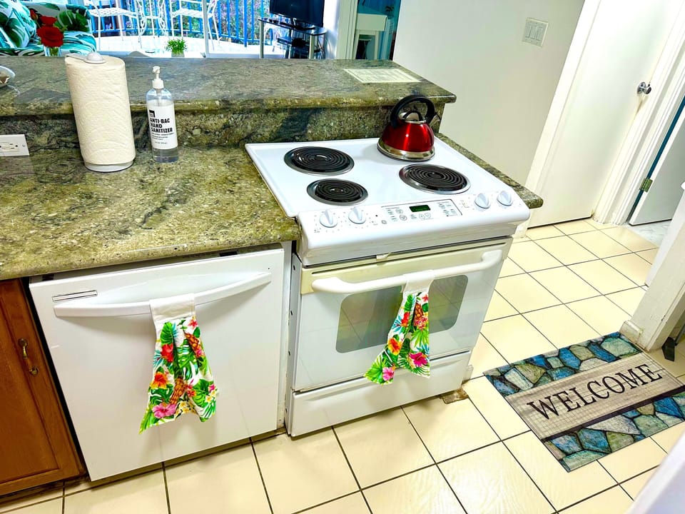 Full kitchen with stove, dishwasher, fridge,  cookware and silverware. 