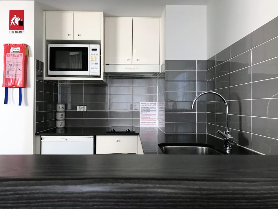 Mini-fridge, microwave, electric kettle, cookware/dishes/utensils