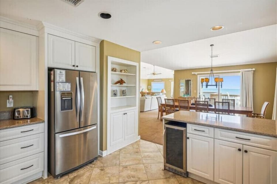 Your fully-equipped kitchen opens to the dining and living areas, with sparkling ocean views just beyond, making every meal prep feel like a coastal retreat.