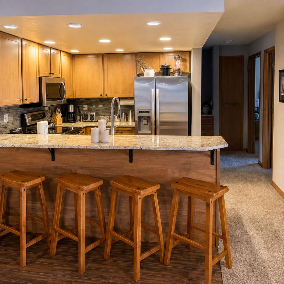 Your fully equipped kitchen features granite countertops, stainless steel appliances, and a spacious breakfast bar where you can gather over morning coffee or prepare your favorite meals.