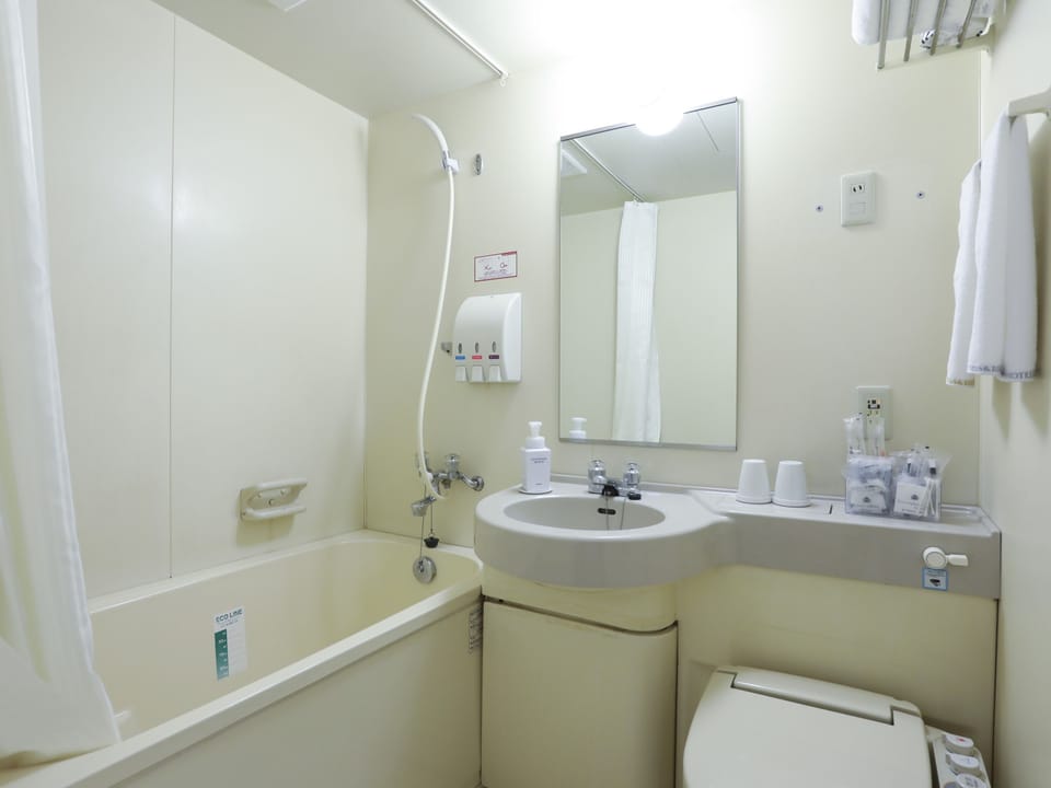 Combined shower/tub, designer toiletries, hair dryer, bathrobes