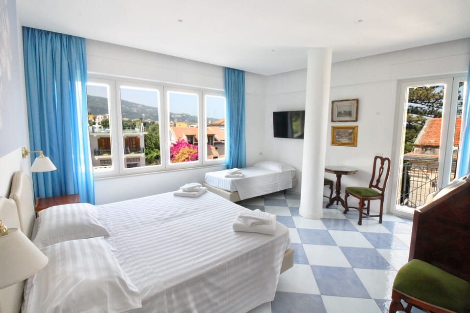 Triple Room | Minibar, in-room safe, desk, blackout drapes