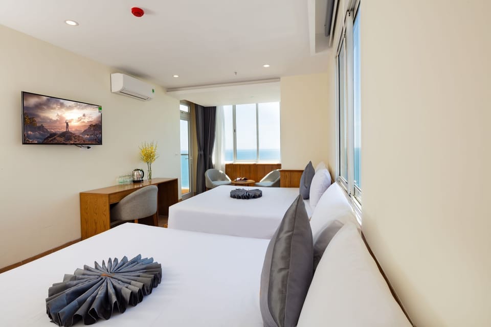 Deluxe Quadruple Room | Minibar, in-room safe, desk, blackout drapes