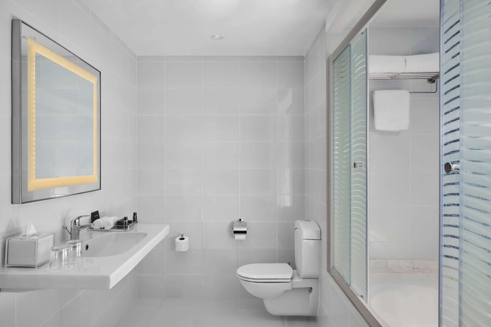Suite, 1 King Bed, Sea View | Bathroom | Hair dryer, bathrobes, slippers, towels