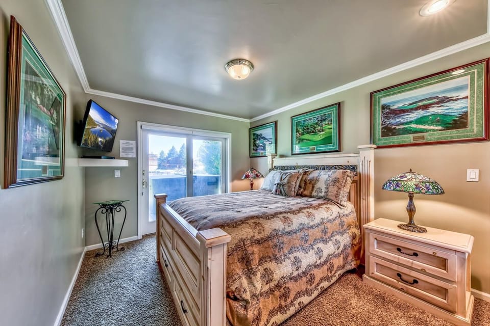 Your cozy bedroom retreat features warm wood furnishings, nature-inspired artwork, and all the comforts you need for peaceful rest.