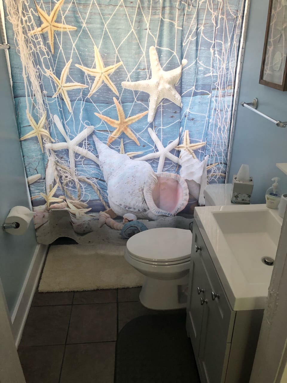 Renovated bathroom with barn door and new vanity/sink. 