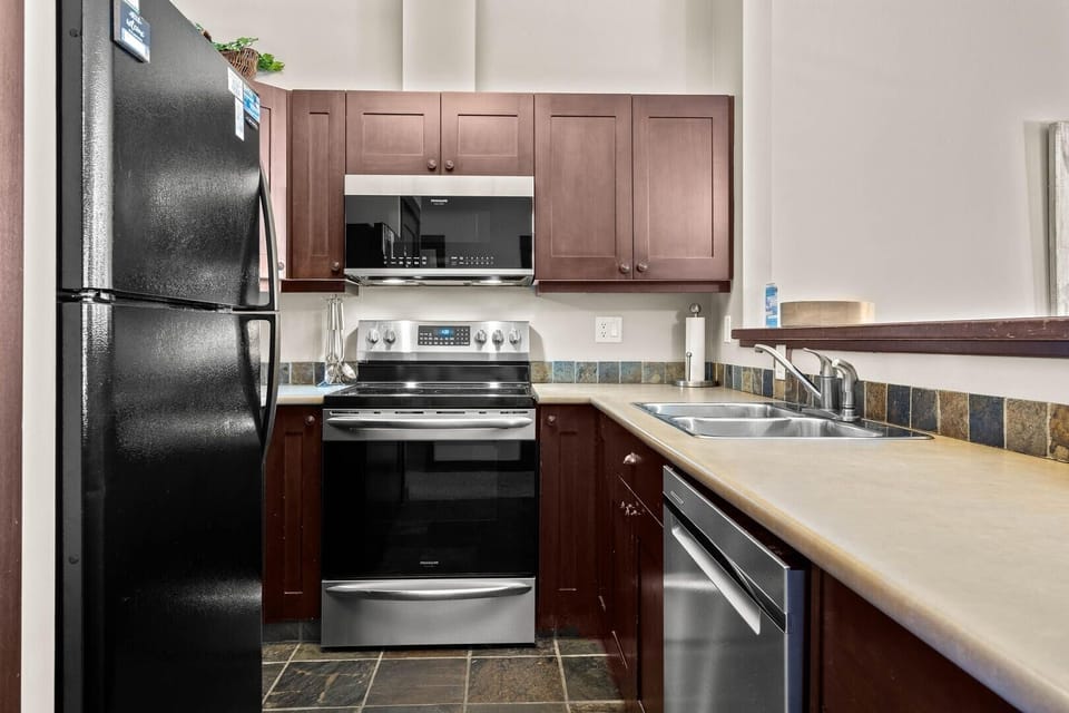 Condo, 2 Bedrooms | Private kitchen | Fridge, microwave, stovetop, dishwasher