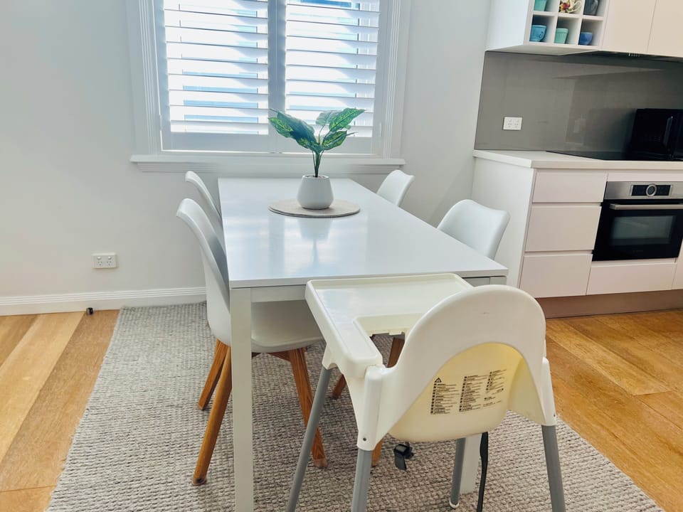 Dining area with 5 chairs plus high chair for infants.
