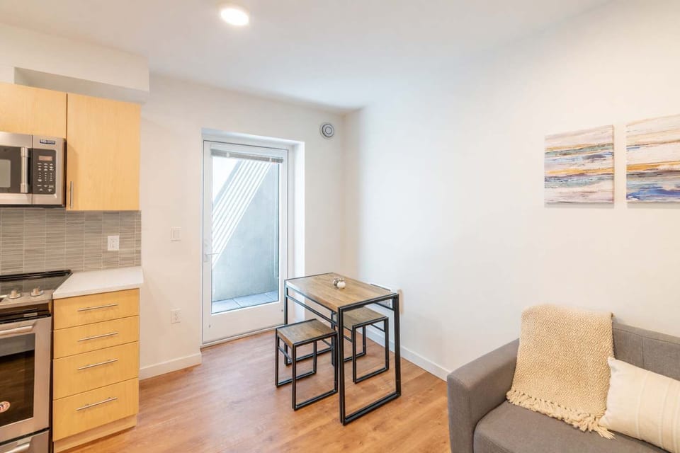 Bright dining nook with modern table, cozy seating, and natural light—perfect for meals, work, or relaxing after a day out.

