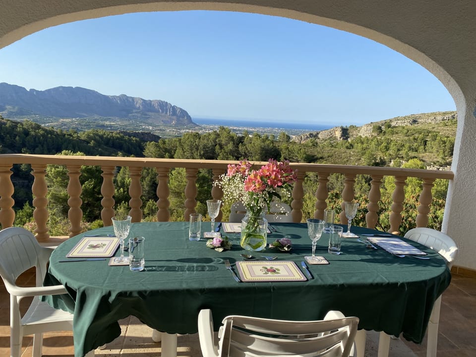 Sunset view from top terrace of pool and mountains