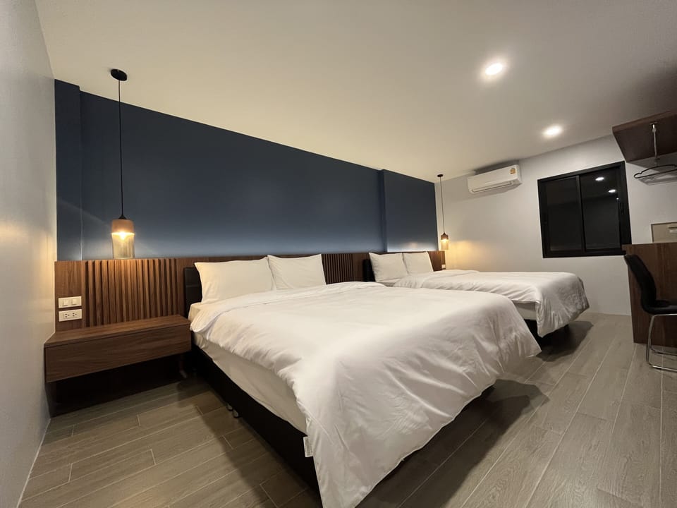 Deluxe Quadruple Room, 1 Bedroom | Minibar, blackout drapes, free WiFi, bed sheets