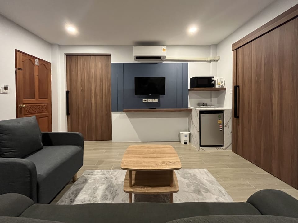 Deluxe Quadruple Room, 1 Bedroom | Living area | Flat-screen TV