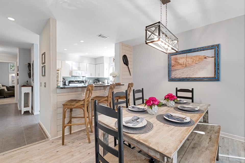 Coastal elegance meets comfort: oversized dining table perfect for morning coffee, evening feasts, or board games with the crew ☀️ — steps from the kitchen and living area in this light-filled Hilton Head retreat.